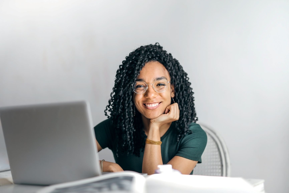 woman smiling in front of a computer